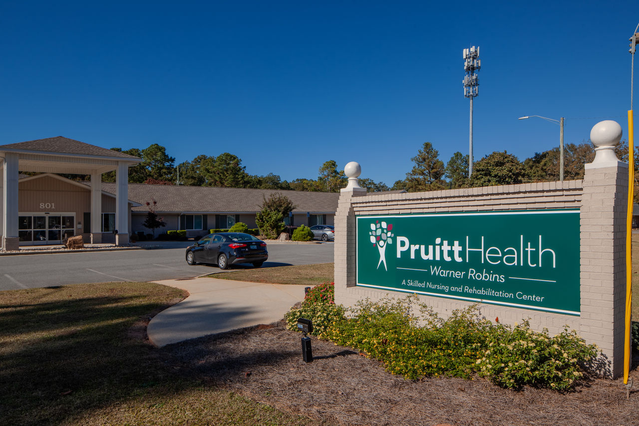 Two CNAs standing in the hallway of a skilled nursing center